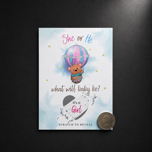 Gender reveal scratch-off card with a teddy bear in a hot air balloon on a dark background