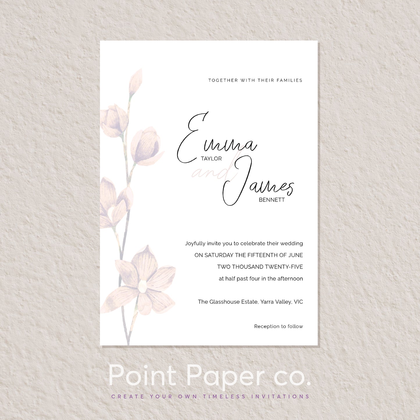 A wedding invitation card with elegant black script and serif text, decorated with soft blush pink watercolor floral stems on a white background, displayed on a textured light beige wall. The brand name 'Point Paper co.