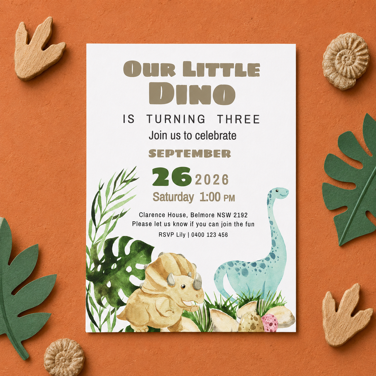 A dinosaur-themed three-year party invitation card styled on an orange background with wooden dinosaur footprint cutouts and fossil decorations.