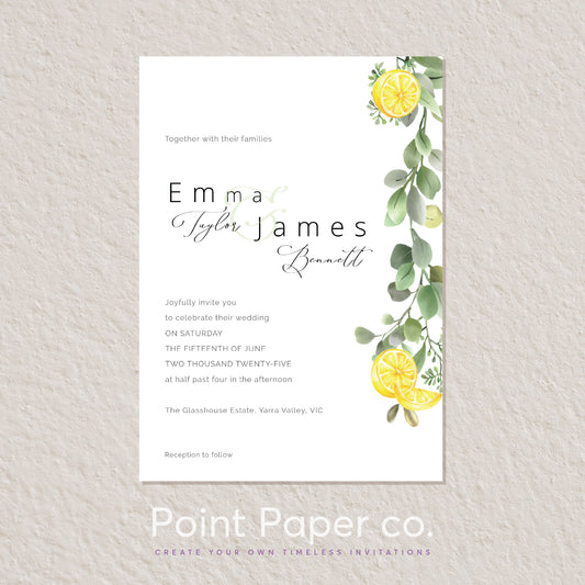 A rectangular wedding invitation card with a white background, featuring elegant black script text and watercolor greenery and lemon illustrations along the right side, displayed against a light textured wall. The card is branded with 'Point Paper co.
