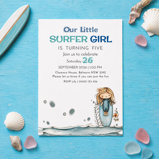 A square birthday invitation card styled as a flat-lay on a bright blue wooden surface, surrounded by seashells, a wooden paddle, and beach pebbles. The card reads 'Our Little SURFER GIRL IS TURNING FIVE' with event details and an illustration of a girl surfing at the bottom.