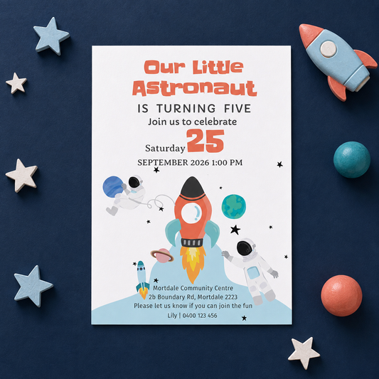 A children's birthday invitation card styled in a flat lay on a dark navy background with toy space props including a small rocket, stars, and balls. The card reads 'Our Little Astronaut IS TURNING FIVE' with event details and space-themed illustrations.